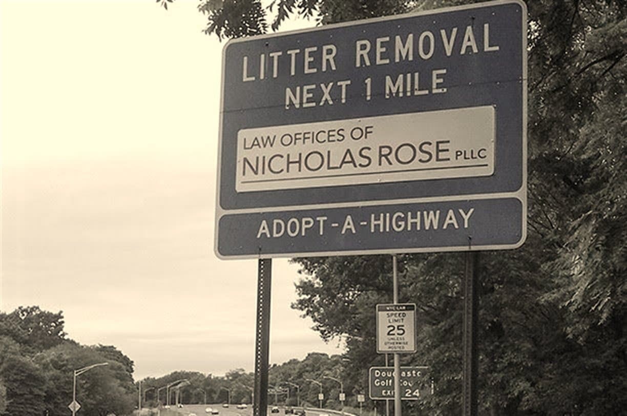Adopt-A-Highway sign reading Law Offices of Nicholas Rose
